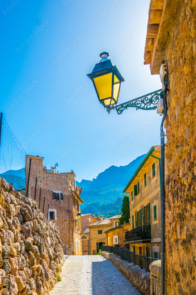 Wall mural A narrow street in the spanish village Fornalutx at Mallorca