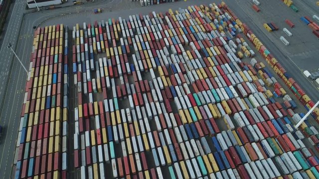 Tilted aerial footage of container terminal and cargo depot in Port of Hamburg, industry economy Germany