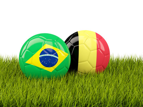 Brazil vs Belgium. Soccer concept. Footballs with flags on green grass