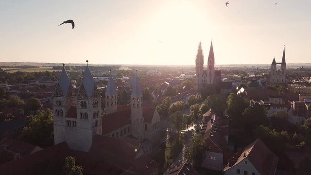 Drone flight over the city of Halberstadt at sunrise ( Harz region, Saxony-Anhalt / Germany )
