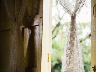 Vintage white curtains on soft light window.