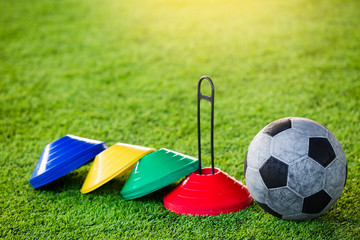 Football and soccer training equipment on artificial turf