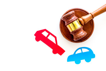Car accident lawsuit concept. Two collided cars near judge gavel on white background top view copy...