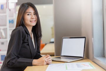 Business woman working in modern office with computer laptop and document for background.