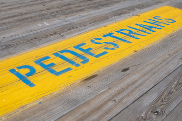 Pedestrian Sign in Yellow and Blue on New Jersey Shore Boardwalk