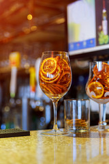 Dried candied orange wheels in large glass container