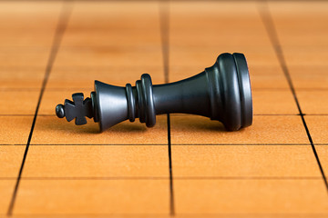 Chess pieces on a wood chessboard