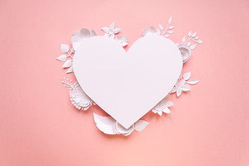 White paper flowers, lined in the shape of a heart on pink background. Cut from paper.