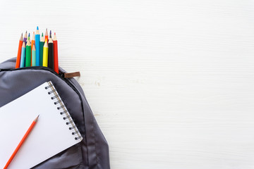 Pencils in school bag with a notebook.