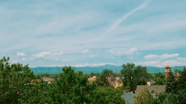 A summer morning time-lapse of the clouds over the city with the Rocky Mountains in the background.