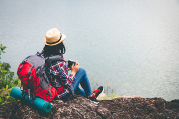 Female tourists in beautiful nature in tranquil scene, concept tourists backpack.