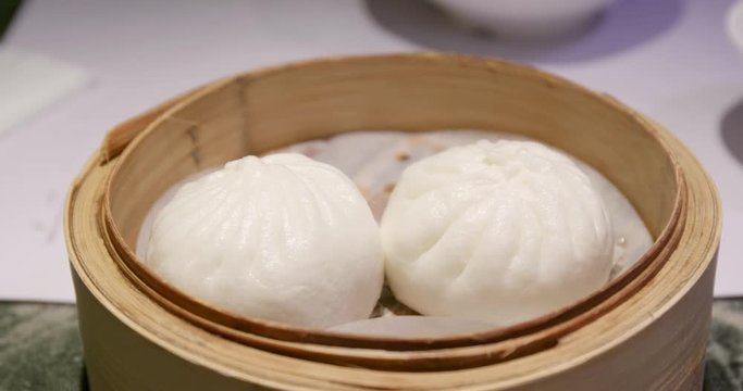 Steamed chinese bun in bamboo basket