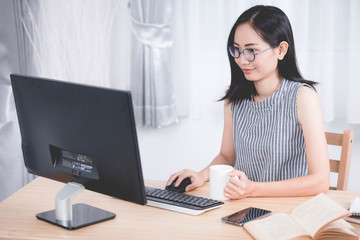 Young asian business woman working with computer .