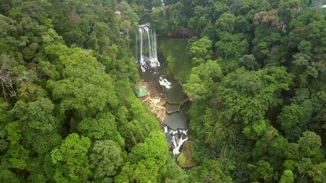 camera rises above canyon surrounded by jungle