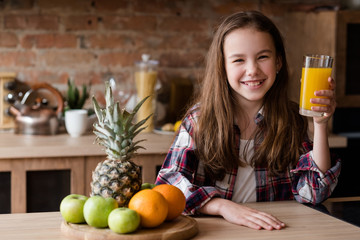 child healthy food and balanced nutrition. fresh orange juice and fruit breakfast. smiling little...