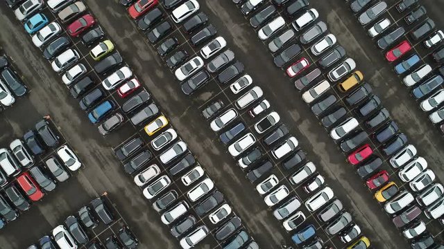 Overhead drone shot of organized parking lot for second hand (used) cars at a large car dealing company in Germany
