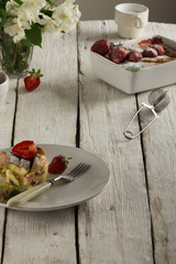 Cottage cheese casserole in white dish decorated with strawberries