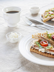 Toasted English bacon & egg a white background