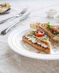 Toasted English bacon & egg a white background