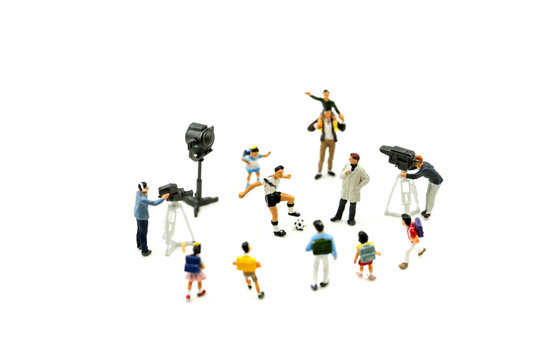 Miniature people : Cameramen, photographers and reporters interviewing football player with children,student.