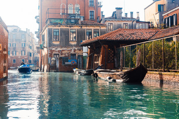 Venetian channel with ancient houses and boats