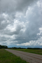 Fototapeta na wymiar Range Road and Farm land in Saskatchewan, Canada.