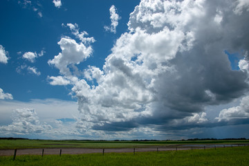 Fototapeta na wymiar Rain clouds approaching above farmland, Saskatchewan, Canada.