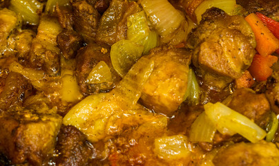 Roast meat, onions, carrots and spices, boiling in oil