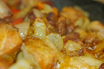 Roast meat, onions, carrots and spices, boiling in oil