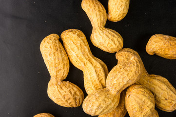 Peanuts in shell on dark background, close up