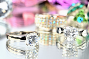 Close-up of artificial stone ring jewelery with reflection and another rings in background