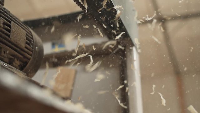 slow motion wood shavings fly in the air. woodworking close-up