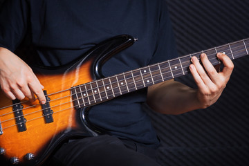 Obraz na płótnie Canvas Rock bass guitarist practicing.