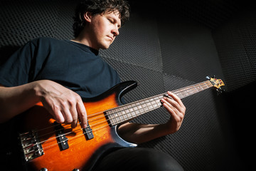 Fototapeta premium Handsome rock bass guitarist practicing.