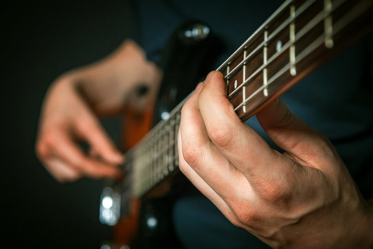 Rock guitarist practicing with bass guitar.