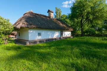 Fototapeta premium An old hut of Smoker Cretaceous with a reed and with an unbreakable foundation in the museum under the loose sky. Uzhhorod Ukraine