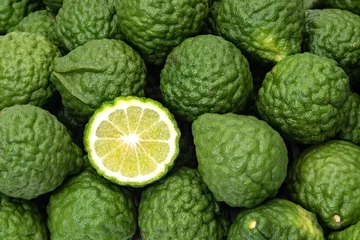 Muurstickers Kaffir limes, one cut citrus fruit for herbal medicine © praethip