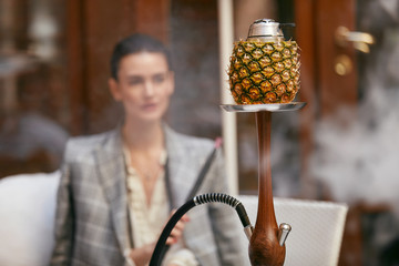 Woman Smoking Shisha In Hookah Bar