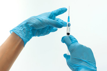 Female hands in blue latex gloves holding syringe isolated on white background