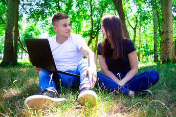 guy with girl in nature with laptop