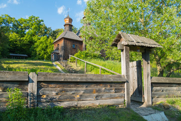 Fence with wicket and old steps leading to the entrance to the authentic wooden church