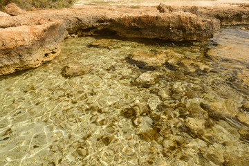 rocky shore with very clear sea water