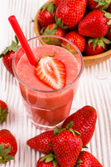 fresh strawberrysmoothie or milkshake on a wooden rustic background