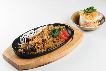 pilaf with salad on a white background