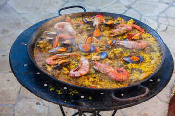 Traditional Spanish paella with seafood and chicken in a pan