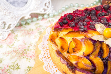 Berry pie, a tart filled with jam made from black currants, in glass form a gray background. Selective focus, close-up.