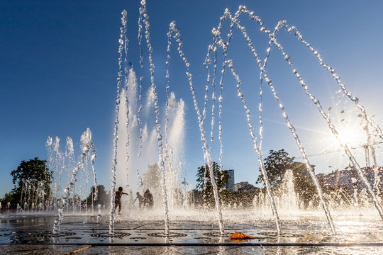 Unidentified Kids playing in the fountain in city park