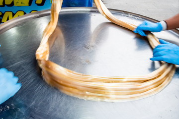 Unidentified people prepare pismaniye,sweet in fine strands