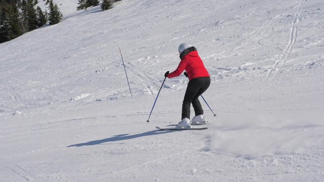 Skier Skiing Down Carving On The Slope In The Mountains In Winter Ski Resort