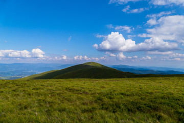 Fototapeta premium trampled path through the top of the mountain against the background of sky blue in the Carpathians